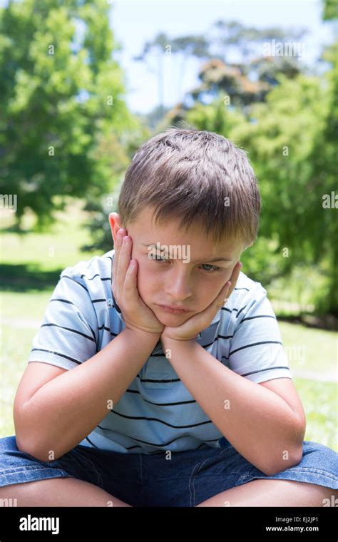 Little boy feeling sad in the park Stock Photo - Alamy