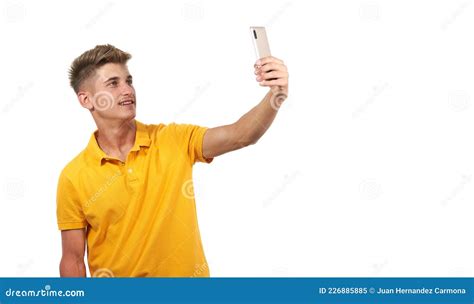 Man In Yellow Shirt Taking A Selfie While Standing Against White