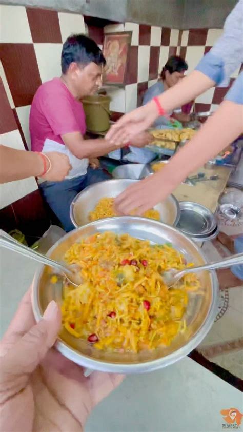 Several People Are Serving Themselves Food At A Buffet