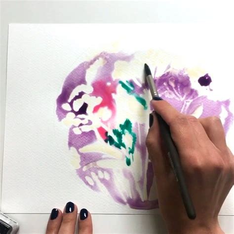 A Woman Is Painting Flowers On A Piece Of Paper With Watercolor Pencils