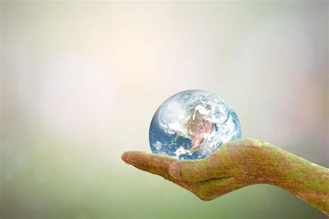 Premium Photo Sustain Earth Concept Human Hands Holding Global Over Blurred Blue Nature