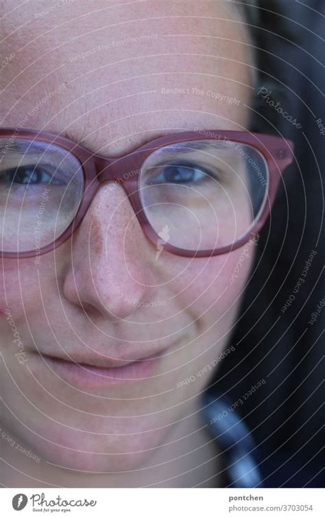 Close-up of the face of a friendly smiling woman with glasses - a ...