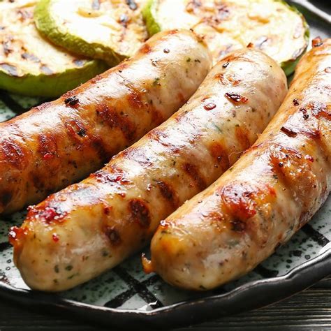 Grilled Sausages And Sliced Apples On A Grilling Pan Ready To Be Eaten