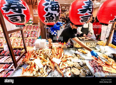 Kuromon Ichiba Food Market In Osaka Fish Mongers Counter Packed With