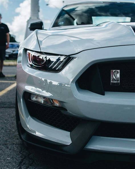 White Mustang Parked In Parking Lot