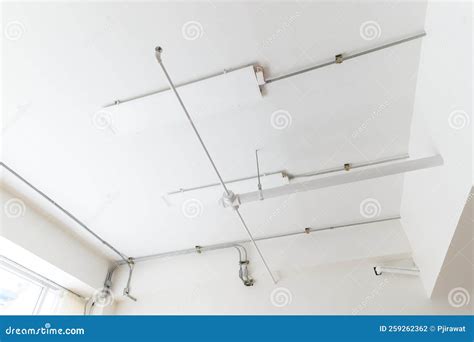 Electrical Wires And Pipes On House Concrete Ceiling Background Plastic Hoses With Cables In