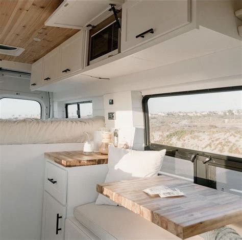 The Interior Of A Camper With Wood Flooring And White Walls Including