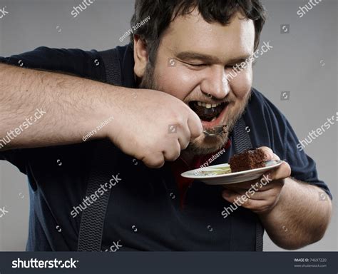 Funny Fat Bearded Man Eating Chocolate Cake He Is Wearing A Dark Blue