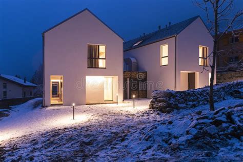 Modern White House With Light Windows Surronded By Mountain Snow And