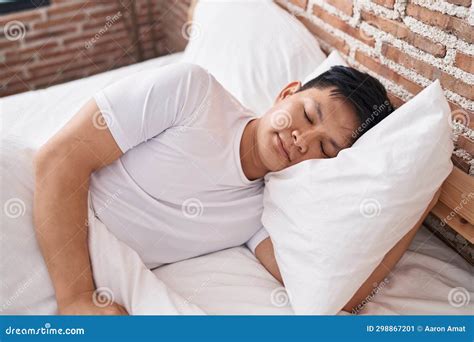 Young Chinese Man Lying On Bed Sleeping At Bedroom Stock Image Image