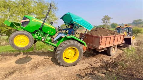 JCB Backhoe Pulling John Deere Tractor JCB 3DX Machine Loading Mud In