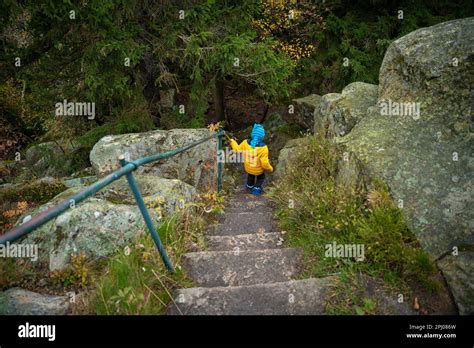The Child Descends The Stone Steps On The Hiking Trail In The Mountains