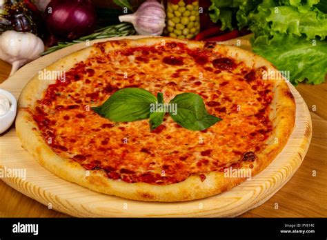 Italian pizza Margarita with basil Stock Photo - Alamy