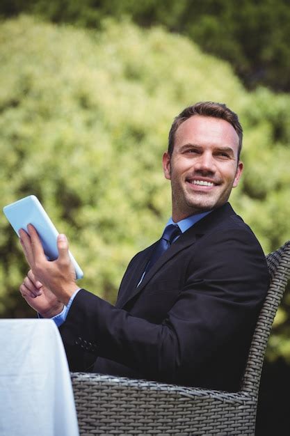 Premium Photo Smiling Businessman Using Tablet