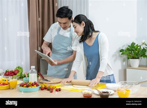 Happy Young Families Making Refreshments Stock Photo Alamy