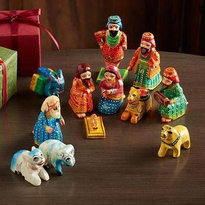 A Group Of Figurines Sitting On Top Of A Table Next To A Gift Box