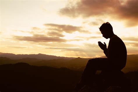 Silhouette Of A Man Is Praying To God On The Mountain Praying Hands