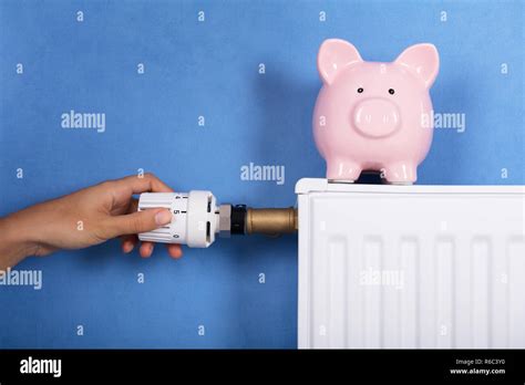 Person Hand Adjusting Temperature On Thermostat Stock Photo Alamy