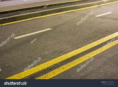 Wide Bright Yellow Street Marking Sign Stock Photo 1256673823