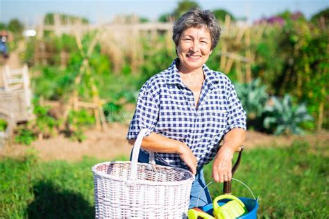 Mature Woman Having Horticultural Instruments In Garden On Day Stock Photo Image Of Adult
