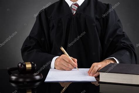 Judge Writing On Paper In Courtroom Stock Photo AndreyPopov 82921216