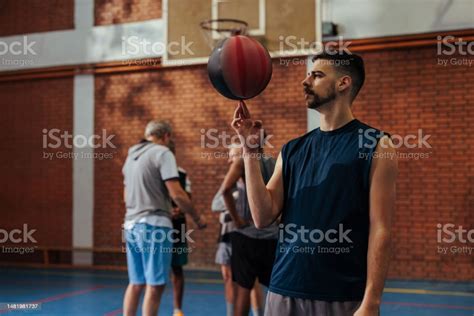 Young Man Spinning Basketball On Finger Stock Photo Download Image