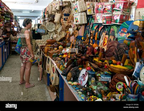 A tourist shopping for local crafts in the market, Castries, St Lucia ...