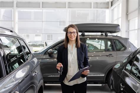 Car Sales At Dealership Female Manager Gives The Keys To The Automobile