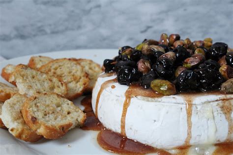 Baked Brie With Balsamic Cherries Pistachios And Cinnamon Honey Zest And Simmer