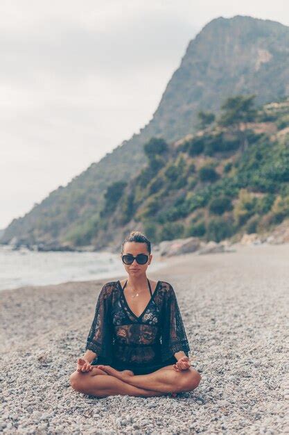 Jolie Femme Assise Et M Ditant Sur La Plage En Robe De Plage Noire