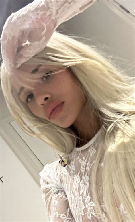 A Woman With Long Blonde Hair Wearing A Bunny Ears Hat And Posing For The Camera