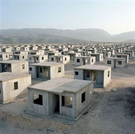 A Large Group Of Concrete Structures Sitting In The Middle Of A Dirt