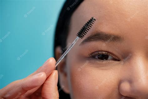 Free Photo Portrait Of Woman Using Eyebrow Brush