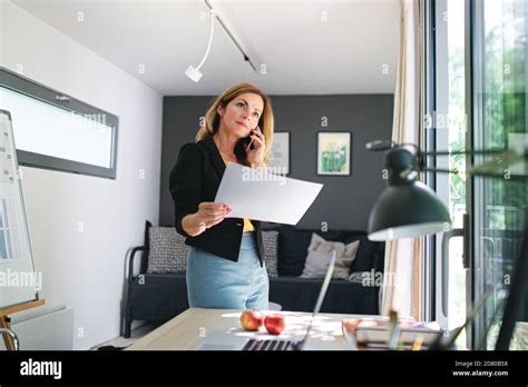 Mature Woman Working Indoors In Home Office In Container House In Backyard Stock Photo Alamy