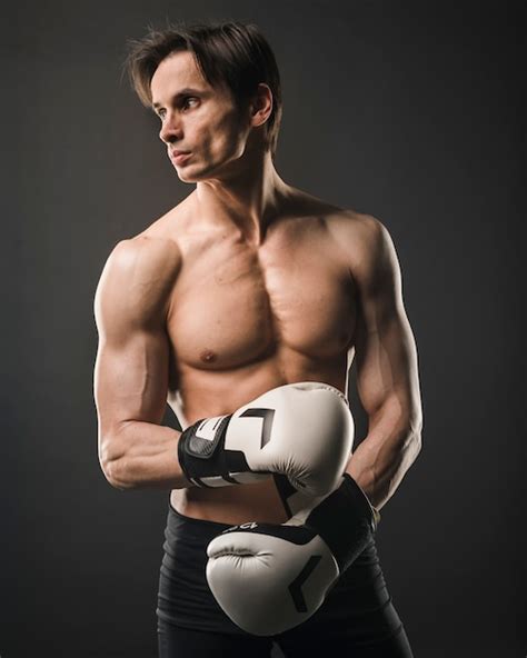 Free Photo Front View Of Shirtless Muscly Man Posing With Boxing Gloves