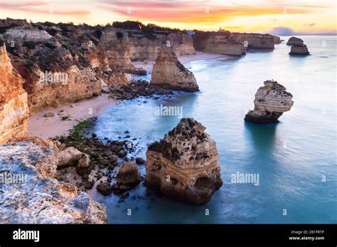 A Colorful Sunrise At The Beach Of Praia Da Marinha Caramujeira Lagoa