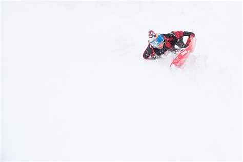 Child Takes A Big Crash While Sledding Stock Photo Download Image Now
