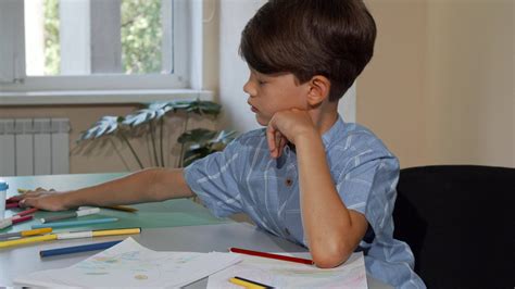 Young Schoolboy Looking Bored While Coloring His Sketchbook 33140975
