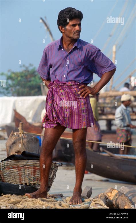 Fisherman On A Traditional Chinese Fishing Net Fort Cochin Kochi