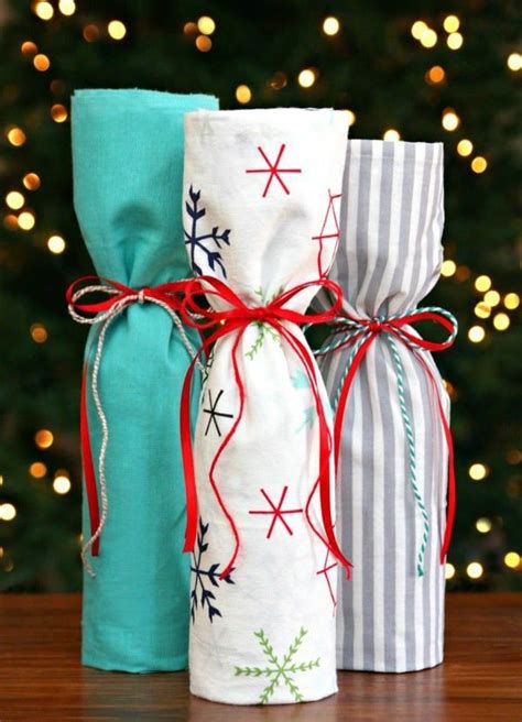 Three Wrapped Presents Sitting On Top Of A Table Next To A Christmas