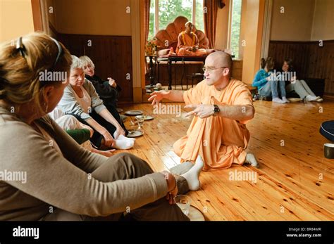 Hare Krishna devotee wearing saffron robes explains his religion to Stock Photo, Royalty Free ...