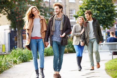 Young Business Couple Walking Through City Park Together Stock Image