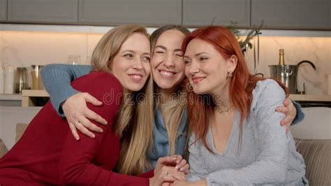 Portrait Of Mature Female Friends Former Classmates Hugging During