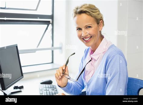 Portrait of teacher smiling in classroom Stock Photo - Alamy