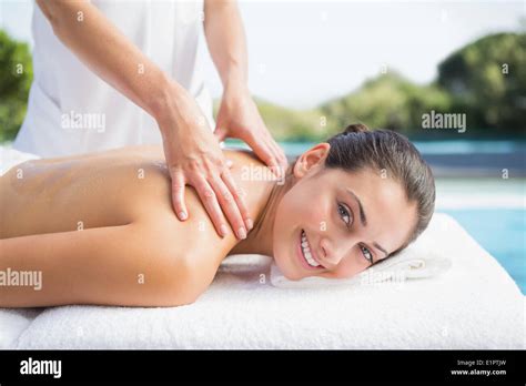 Happy Brunette Getting A Massage Poolside Stock Photo Alamy