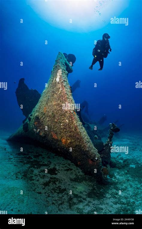 A Scuba Diver Explores A Sunken Shipwreck At The Seabed Of The Aegean