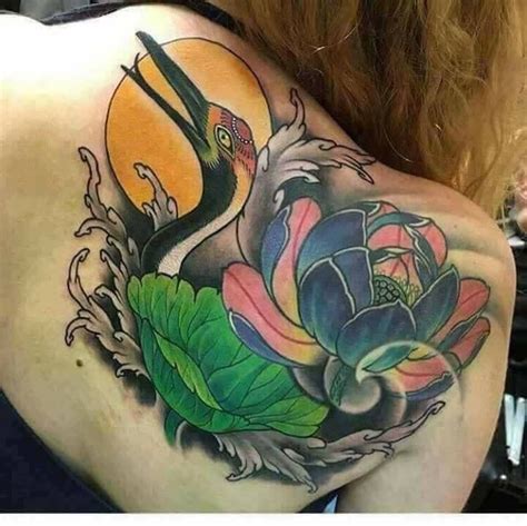 The Back Of A Woman S Shoulder With Flowers And Birds On It