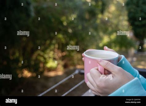Woman Drinking Hot Drink Standing On The Balcony Stock Photo Alamy