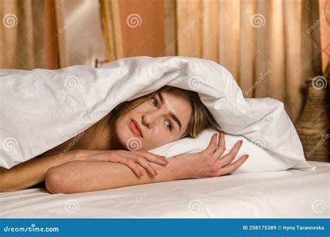 Beautiful Young Woman Wakes Up In Morning In Bed In Rays Of Sun