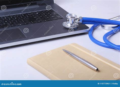 Workplace Of Doctor With Laptop Stethoscope And Notebook On White